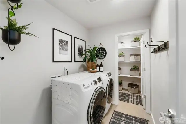 Welcome to the upstairs laundry room, where practicality seamlessly marries elegance, creating a haven that simplifies your daily laundry routine. This thoughtfully designed space is a testament to efficient functionality without compromising style. Open shelving units, adorned with woven baskets and decorative containers, offer additional storage for items like extra linens, cleaning supplies, and laundry baskets. These elements keep everything neatly arranged and within easy reach. Sleek and efficient appliances are seamlessly integrated into the room's design, featuring a high-efficiency washer and dryer set. Their modern design complements the room's aesthetic while delivering top-notch performance....