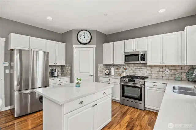 Kitchen boasts stainless steel appliances and quartz counter tops