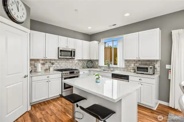 Kitchen has plenty of counter top space and an abundance of cabinetry