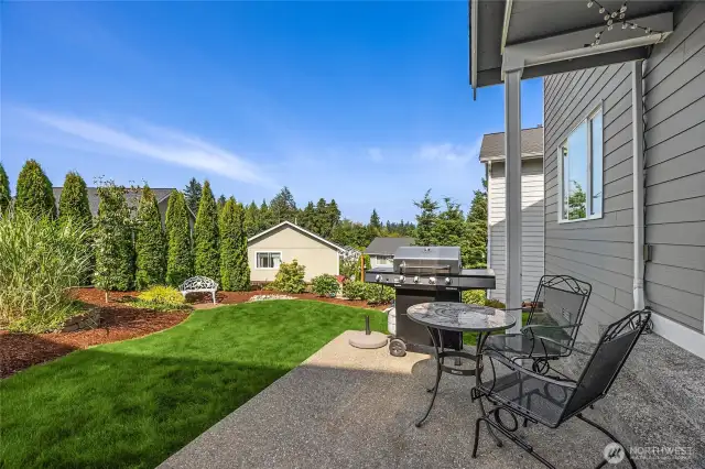 Backyard features a lush and level lawn space
