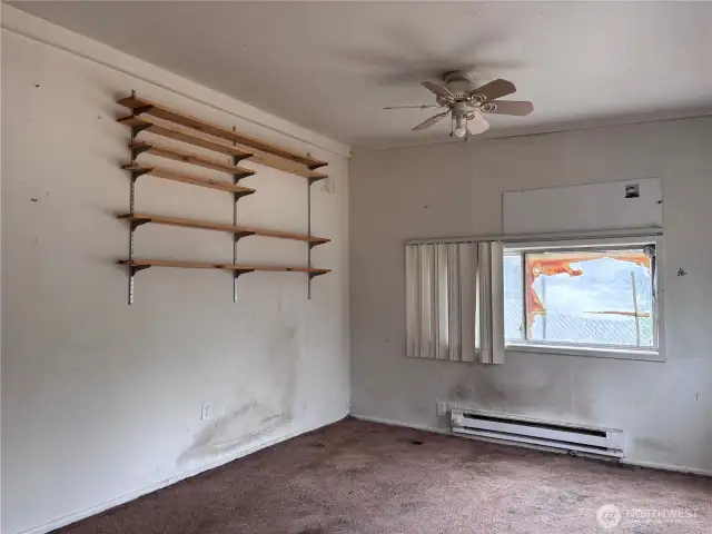 The bedroom has a ceiling fan