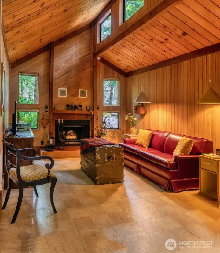 Lovely interior boasting clerestory windows, warm wood interior, soft lighting and a cozy fireplace.