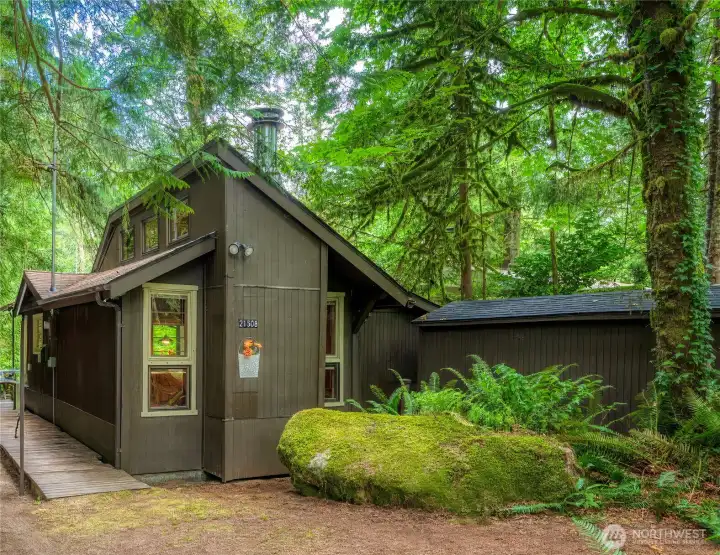 A moss-covered boulder makes an inviting entrance.