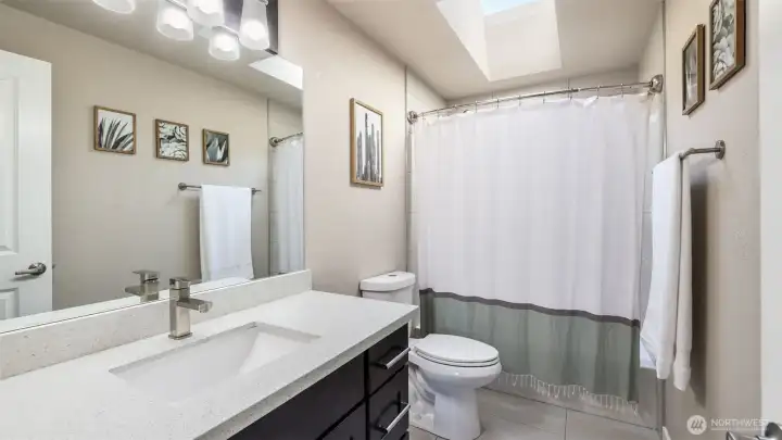 A full guest bath that blends function with polished design with plenty of natural light.