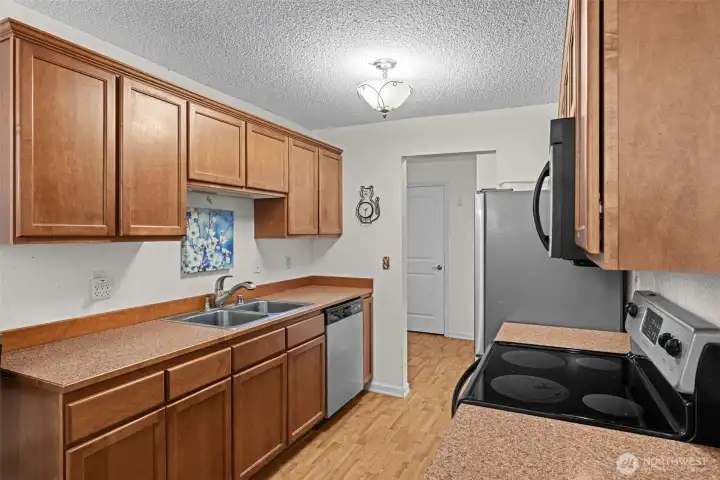 The upgraded kitchen has stainless steel appliances, a luxury laminate floor and plenty of storage and workspace.