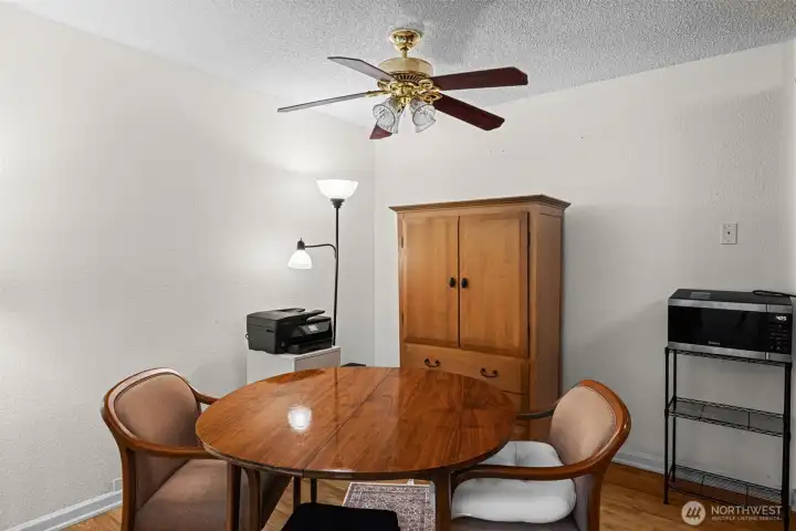 The dining room also has luxury laminate flooring, plus a ceiling fan.