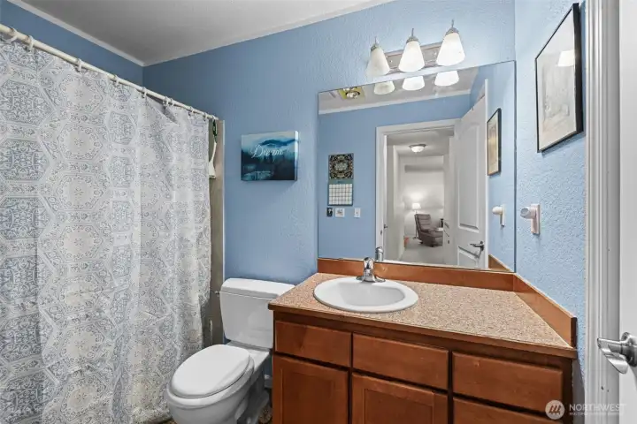 The bathroom has storage and counter space.