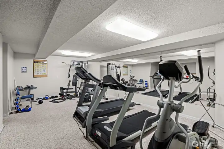 The workout room offers multiple fitness machines.