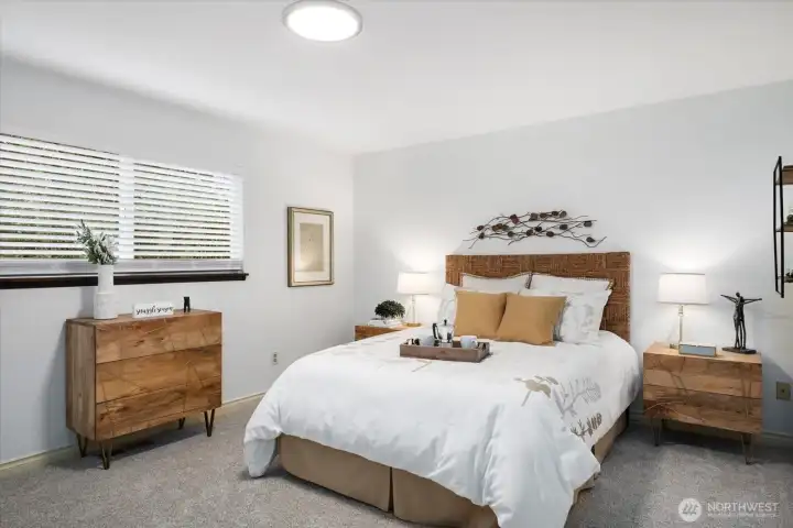 Primary suite is the perfect place to unwind at the end of the day, complete with dual closets, en-suite bath and lush garden views.