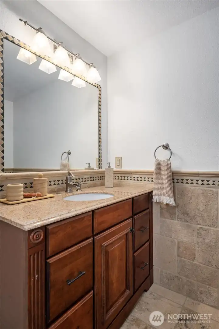Beautiful vanity in the primary bath with meticulous detailing, and tile work!