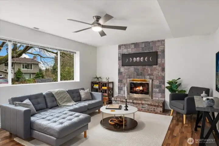 Lower level family/bonus room features ceiling fan, large picture window, and gas fireplace!