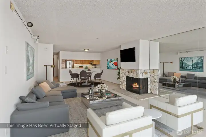 From the vantage point of the living room, the eye is drawn seamlessly into the dining area, where the space opens further into the kitchen beyond—creating a continuous, flowing layout that connects each zone while maintaining its own distinct character.