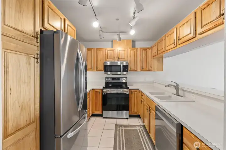 The updated kitchen boasts sleek stainless-steel appliances, all approximately one year old, offering a modern look along with reliable, like-new performance.