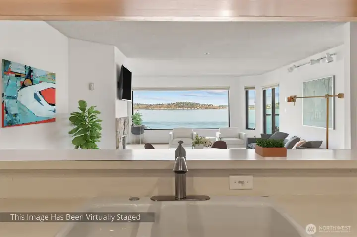 This thoughtfully designed floorplan showcases a seamless flow from the kitchen into the dining and living areas, all oriented toward a stunning, expansive view. The open-concept layout creates a bright, inviting atmosphere that’s perfect for both everyday living and entertaining. Here, even routine tasks take on a new appeal—cooking and cleaning become enjoyable experiences as you stay connected to the space around you and the scenery beyond. Living here means turning once-ordinary moments into something truly special.