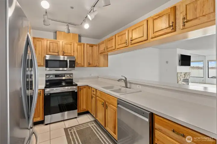 A fresh perspective on the updated kitchen, featuring sleek stainless-steel appliances that are just one year old, combining modern style with everyday functionality.