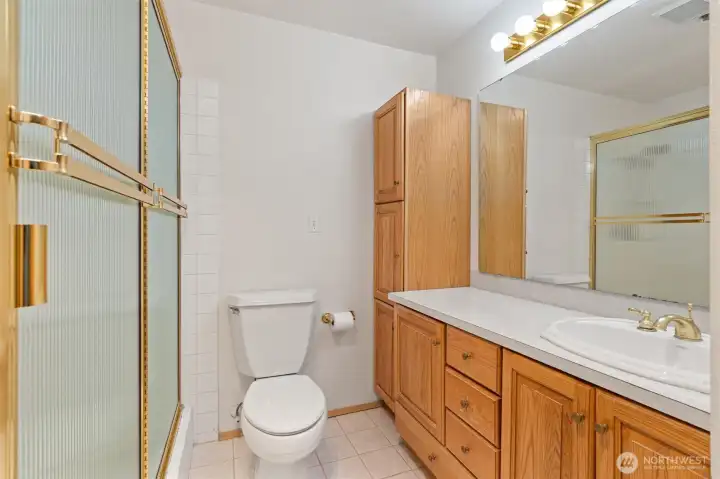 Primary suite featuring a 3/4 bathroom with tile flooring and a convenient step-in shower, offering both style and functionality.
