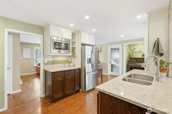 The kitchen has stainless steel appliances and a tile backsplash.