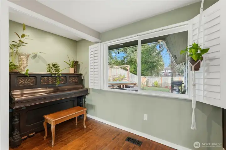 The dining nook have oversized windows that look out to the back deck and yard.