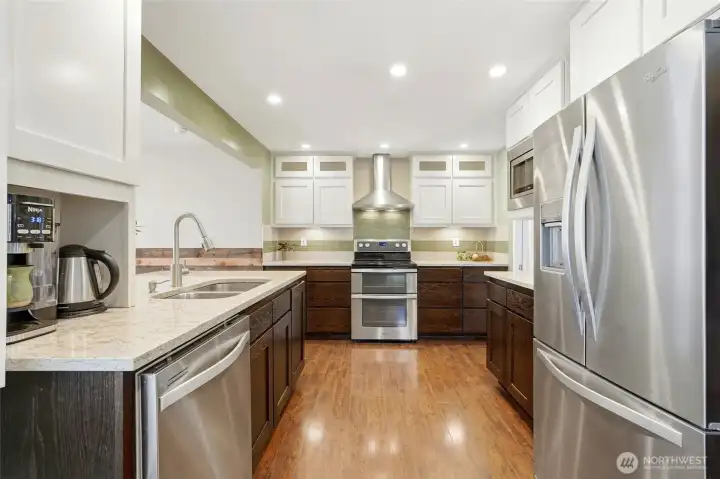 The kitchen has stainless steel appliances and a tile backsplash.
