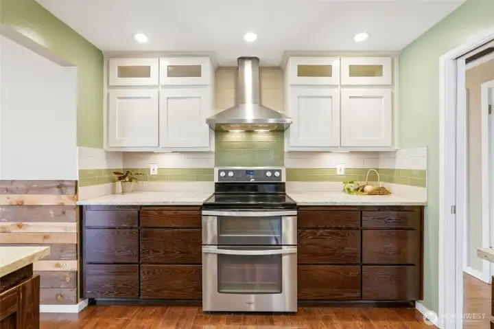 The kitchen has stainless steel appliances and a tile backsplash.