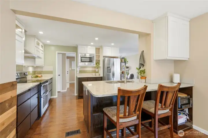 Kitchen features a bar with storage underneath.