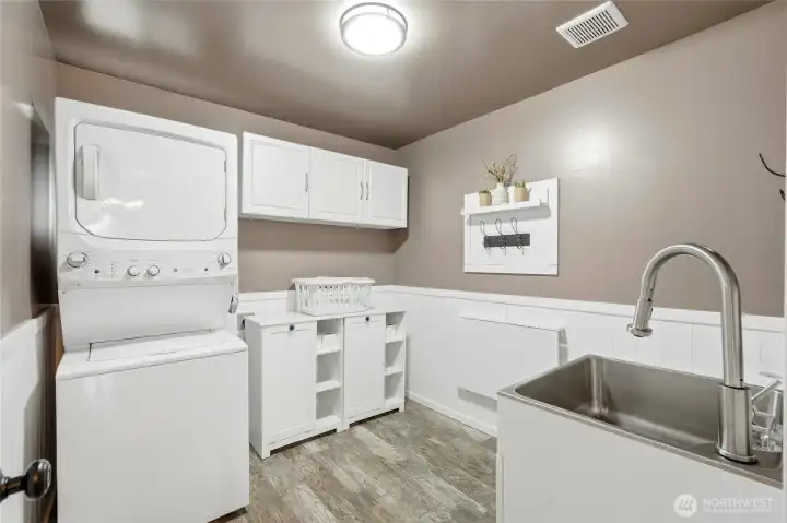 The laundry room has plenty of room to fold. And a half bath for everyday use and visitors.