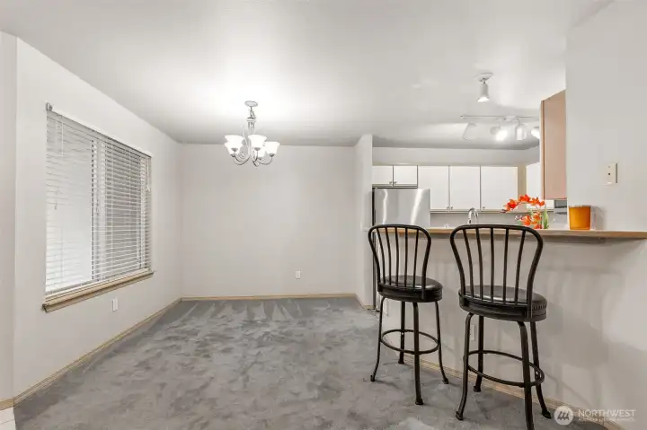 Dining Area off Kitchen with Breakfast Bar & View of Private Covered Entry Patio