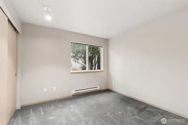 Bedroom 2/Office Space with Closet & Landscape View between Buildings