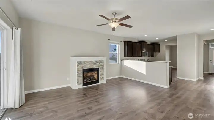 Inviting family room featuring a cozy gas fireplace with custom mantle—perfect for relaxing evenings at home.