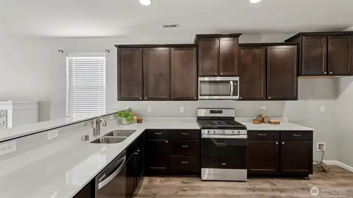 Abundant cabinetry and thoughtful layout provide tons of storage for cookware, appliances, and more.