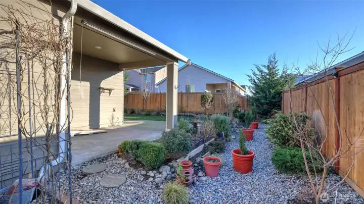 Huge covered porch and beautifully landscaped side yard and your own blue berry patch!