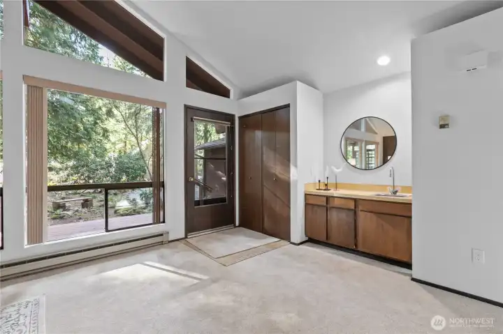 Large windows frame peaceful forest views and bring in natural light.