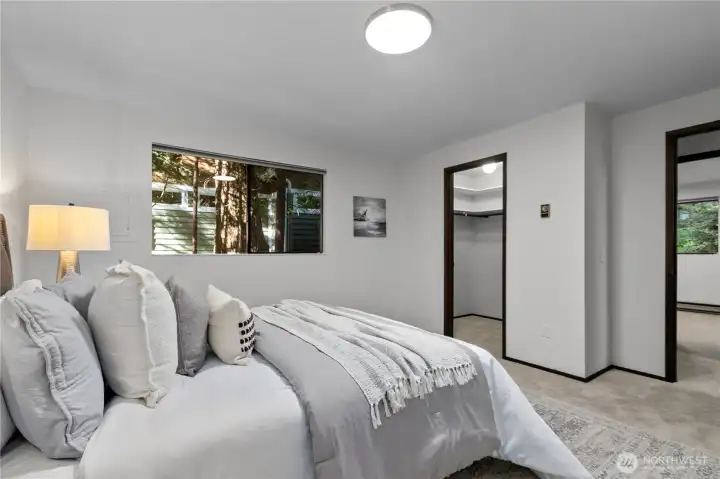 Spacious primary bedroom with peaceful outlook.