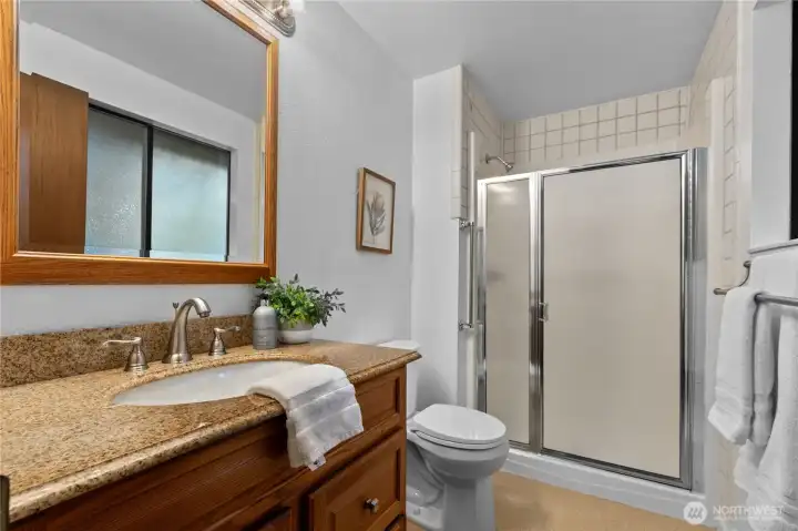 Primary bath with updated vanity and walk-in shower.