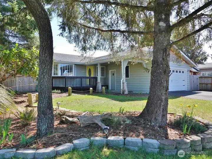Front of the home w/ landscaped front and back yards.