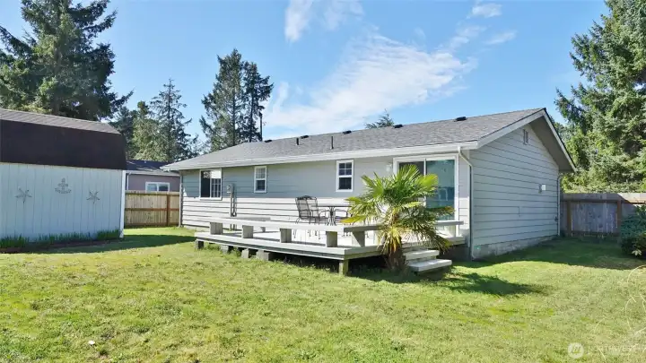 Rear view of the home w/ Deck, Shed and Fenced Backyard.