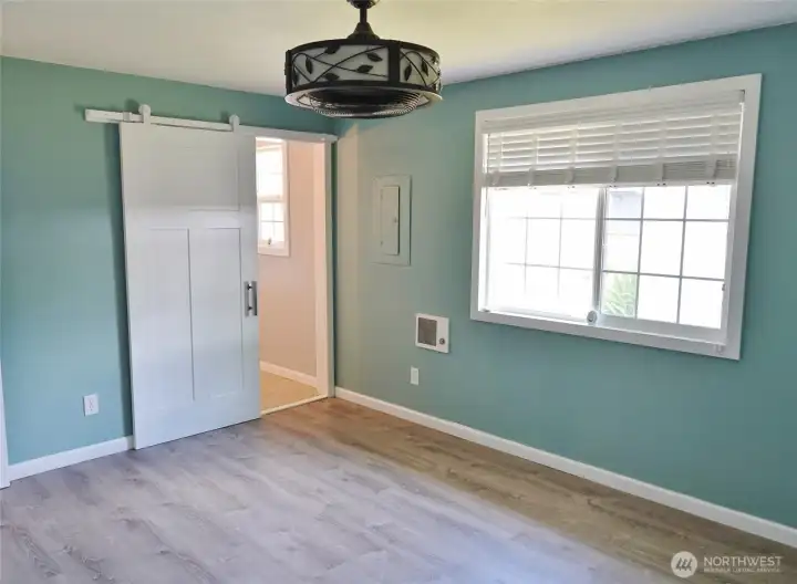 Master Bedroom w/ a "barn-style" door leading its private bathroom.