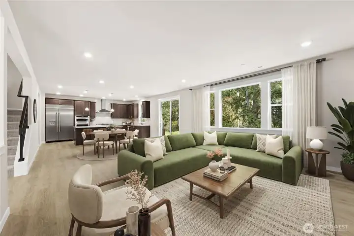 Bright and inviting great room with seamless open-concept living, dining and kitchen. Photo contains virtual staging.