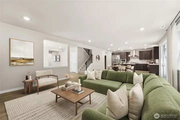 Great room with open sightlines to the kitchen and dining area, perfect for relaxed and easy living. Photo contains virtual staging.