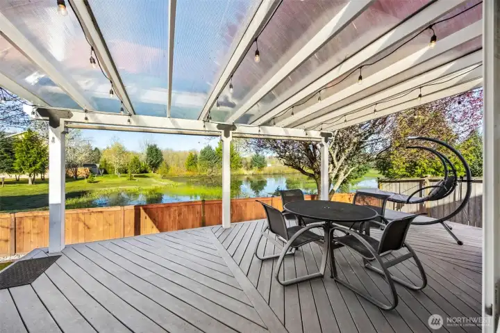 Beautiful view from the large composition covered deck. Perfect for an evening of BBQing- this home also has a natural gas connection for the grill.