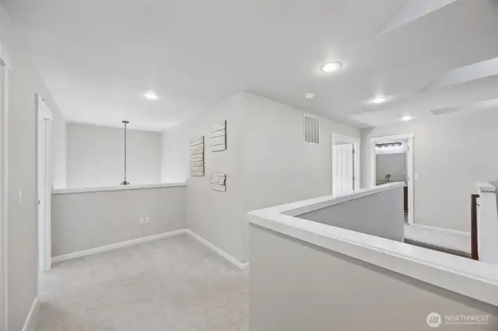 Upstairs loft area with white millwork & three skylights that open to the downstairs entry.
