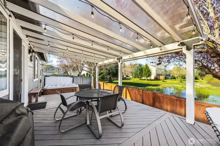 ENTERTAINERS dream! Covered backyard deck over looking a nice pond. Sit outside and enjoy dinner or sit outside and enjoy the rain hitting the roof!