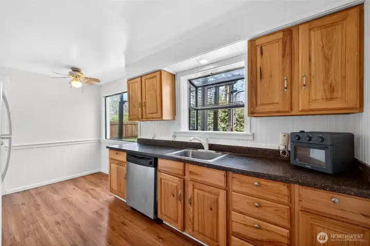 Kitchen view with more windows of back yard and lots of natural light