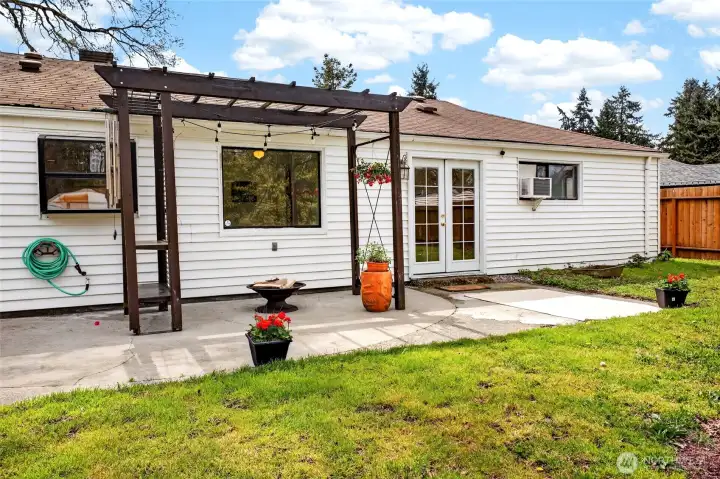 View of large back patio with pergala to relax in afternoon sun