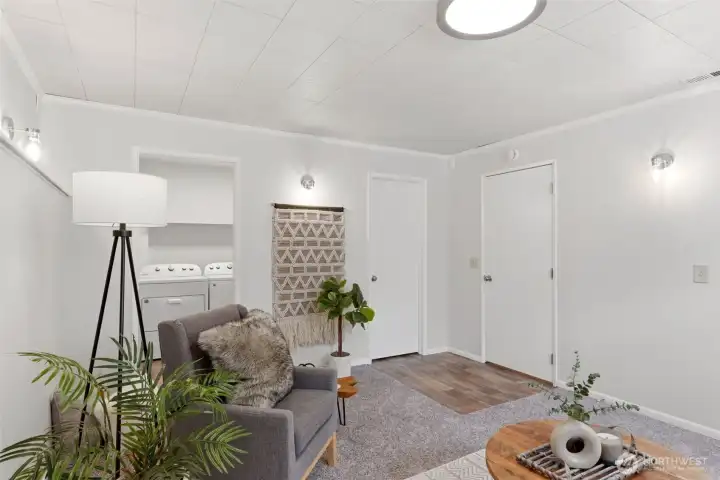 This area connects to a half bathroom, laundry area, and a closet. Ideal for a recreation room, office, or guest room.