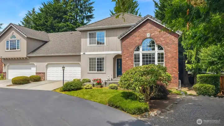 Corner-unit townhome with two car garage. Gravel parking area is not associated with the home, but can be used for parking.