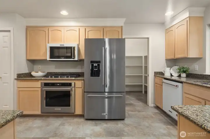 Spacious kitchen with stainless steel appliances.