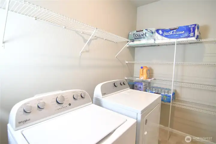 utility room next to hallway and garage door entrance