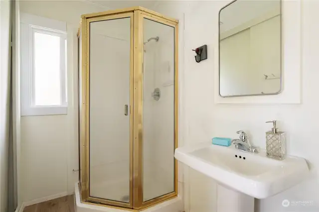 Step into the 3/4 bath adjacent to the primary bedroom which has a stand-up shower, pedestal sink & window that lets in light. A storage closet is perfect for storage of towels and extra pantry items.