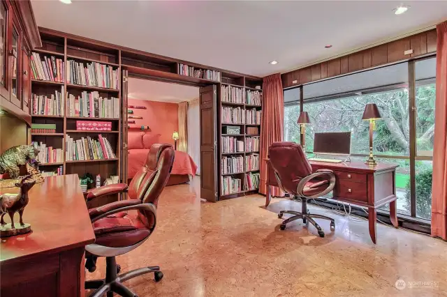 Office suite opens to the primary bedroom. The built-in bookshelves are amazing.  Imagine sitting at your desk with a lovely golf course view.
